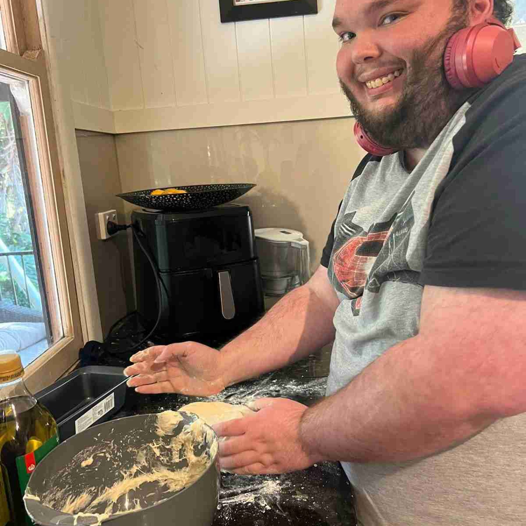 A man smiling while baking