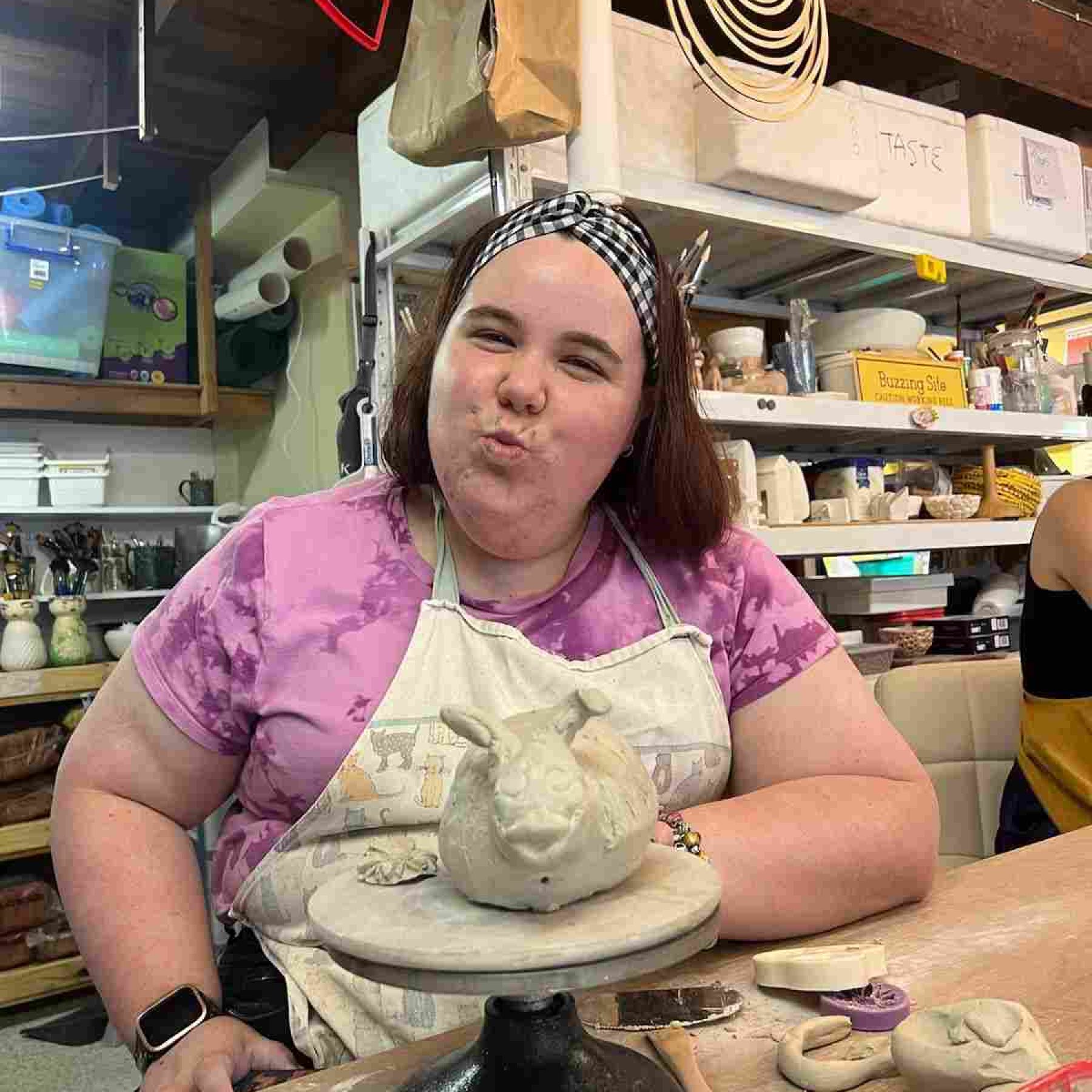 A woman smiling while doing art crafts