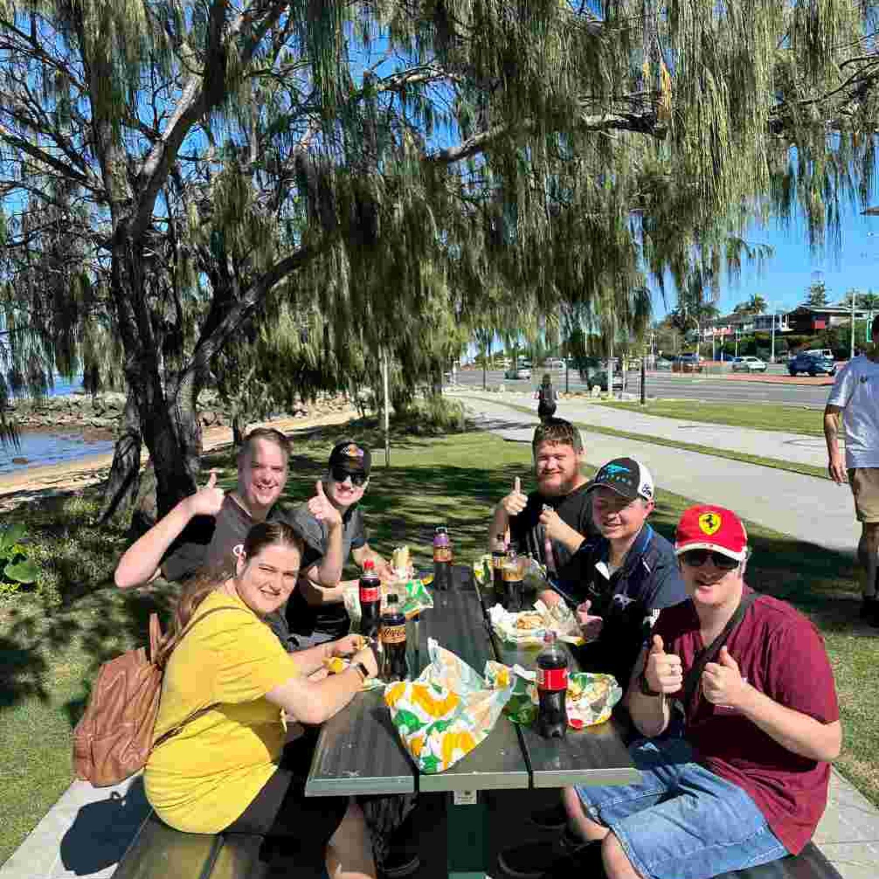 Group of people smiling while doing thumbs up