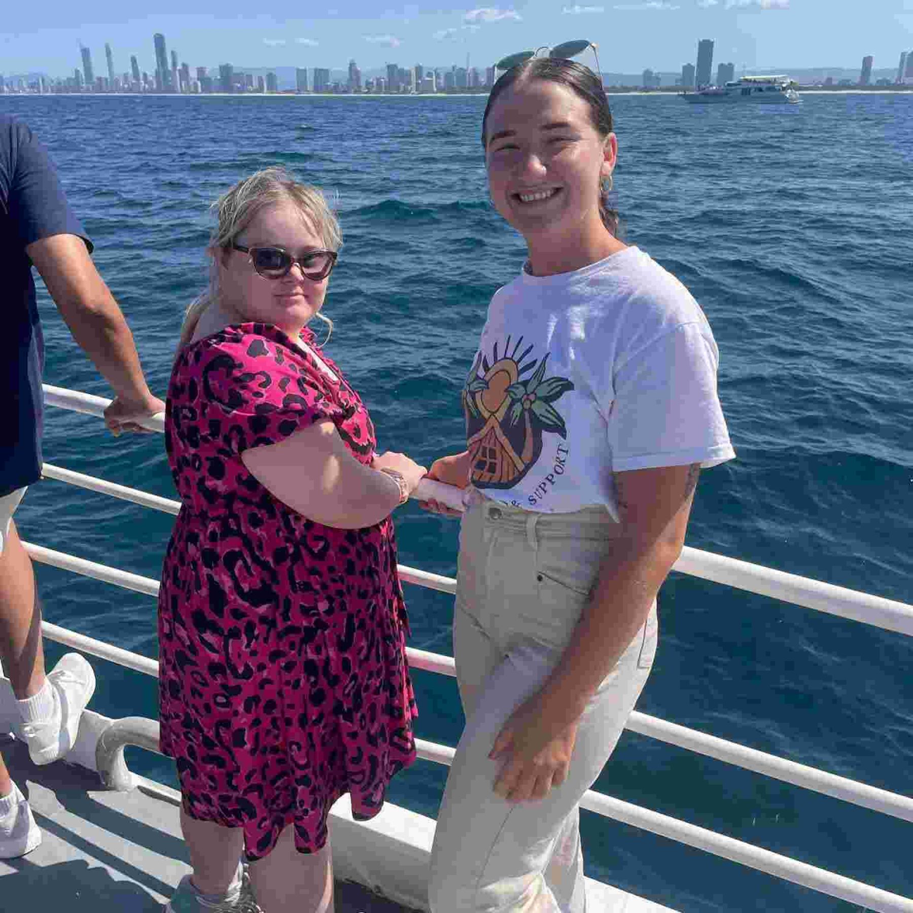 A disabled girl and her support worker in a boat