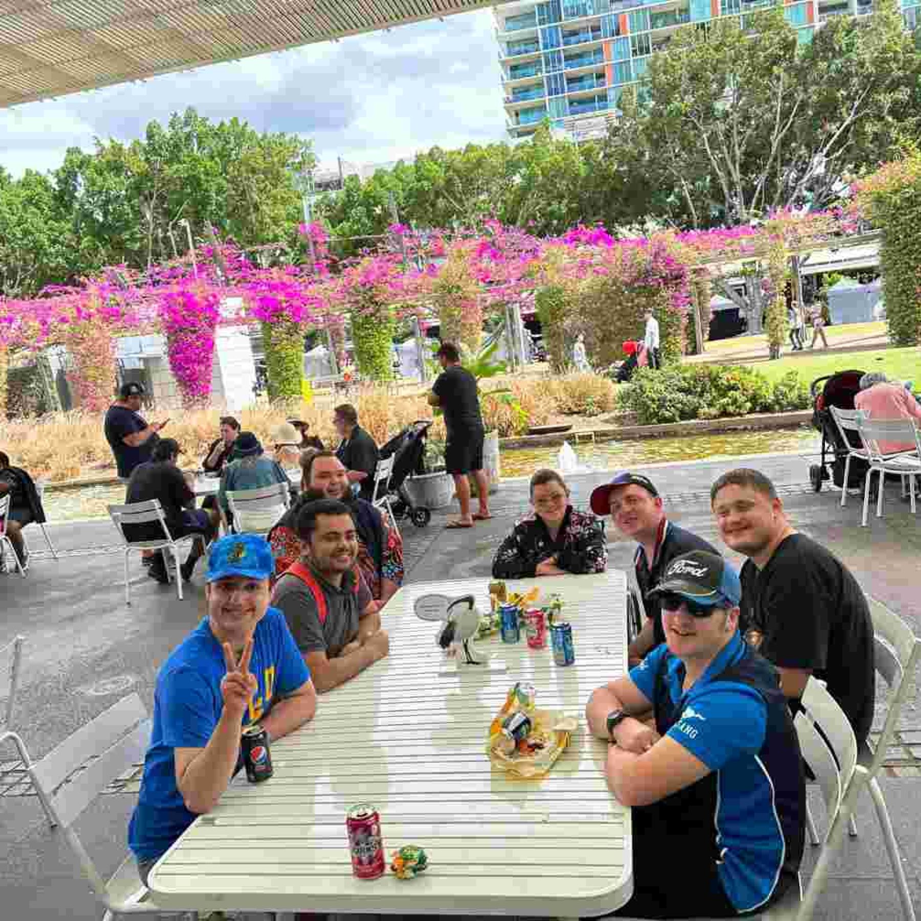 Group of people smiling while sitting down in a chair