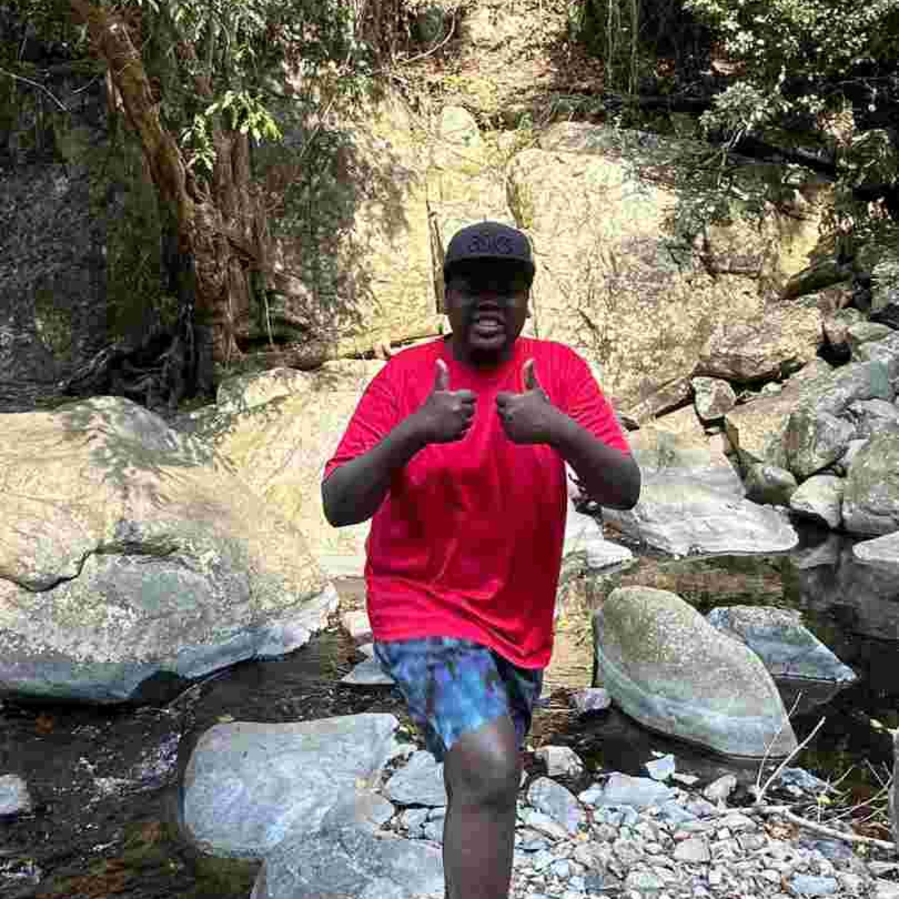 A man smiling while doing thumbs up