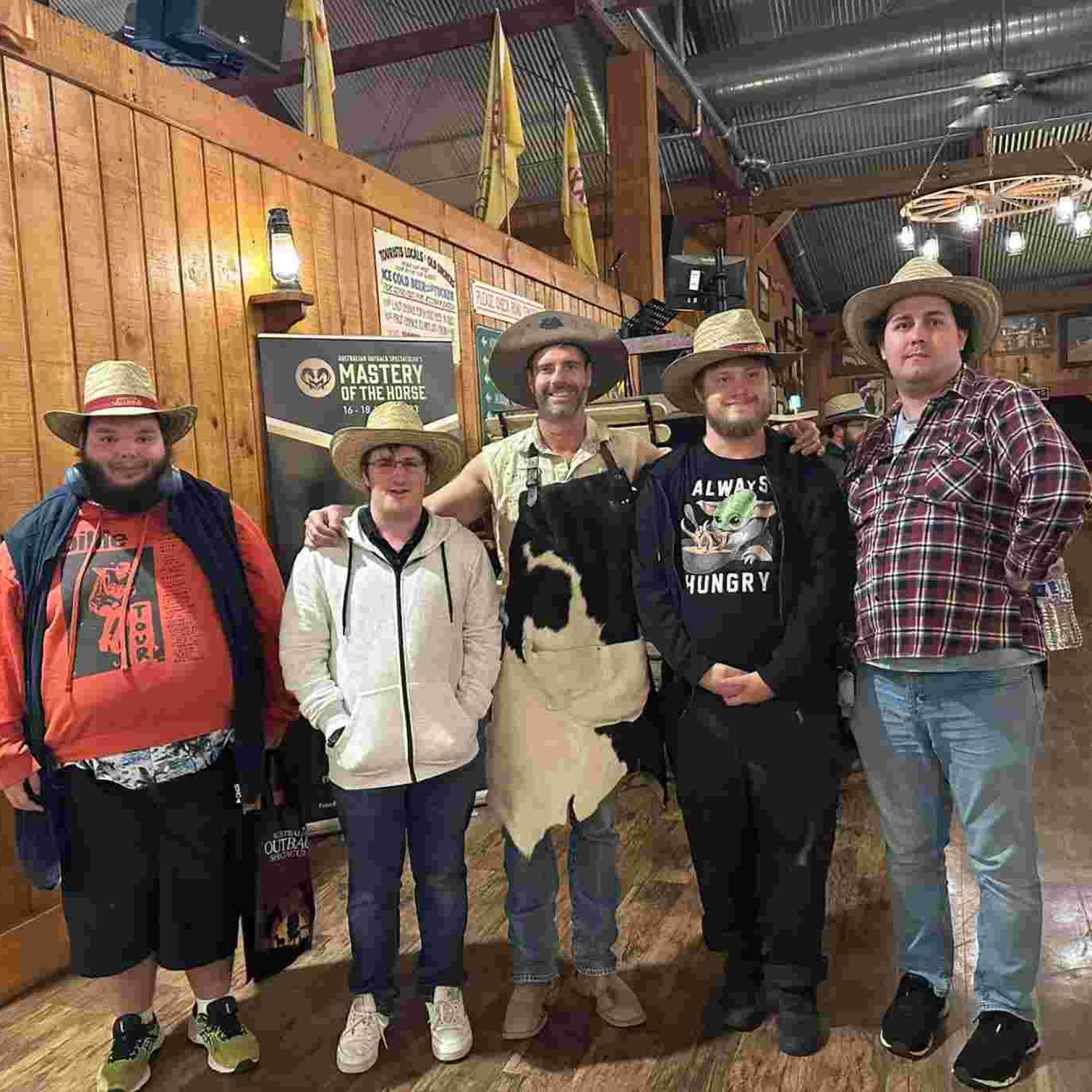 Group of people smiling in their cowboy hats