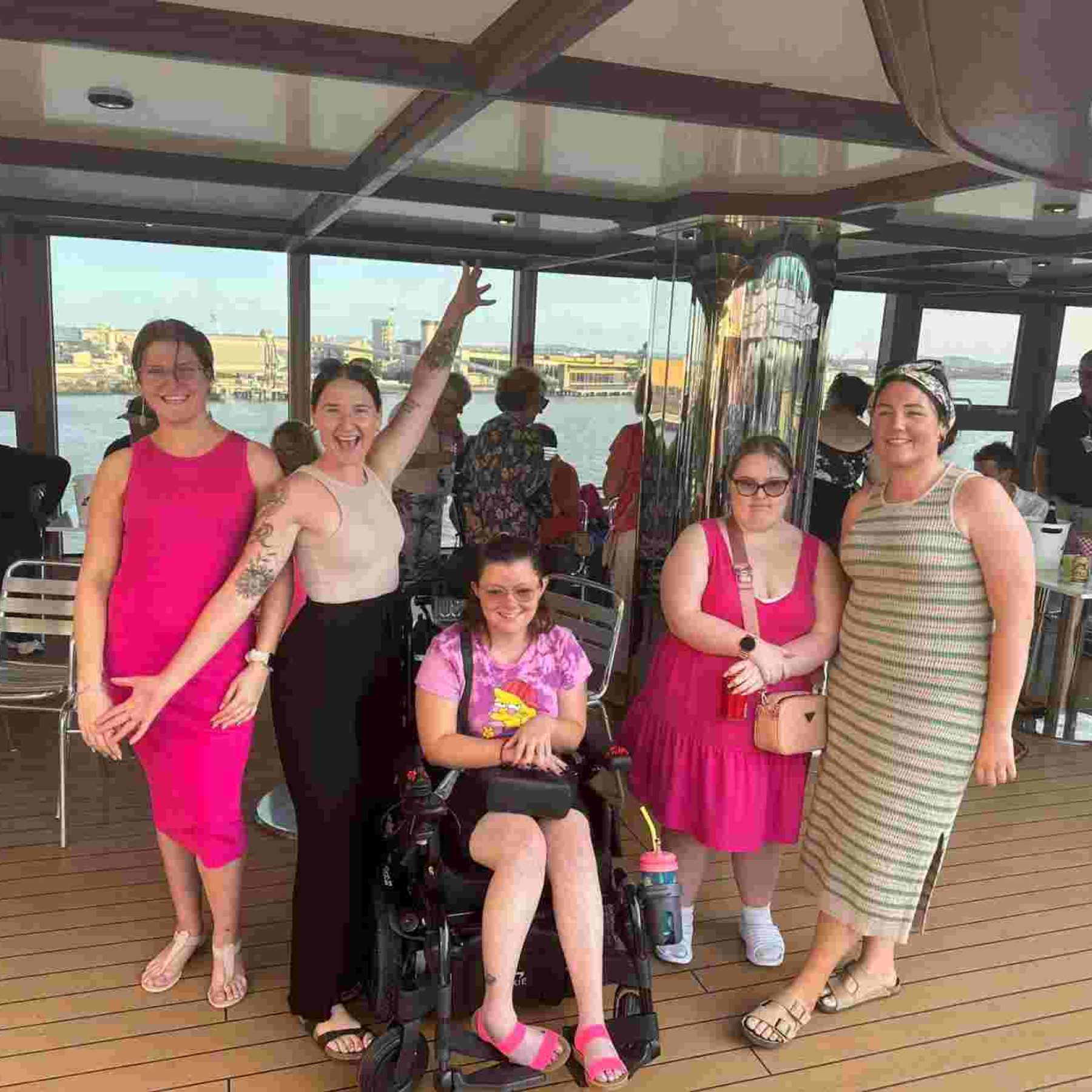 Group of girls and one disabled girl in her wheelchair smiling